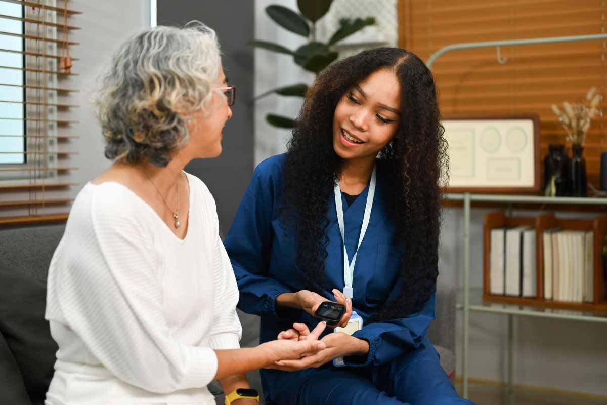 female caregiver checking blood glucose